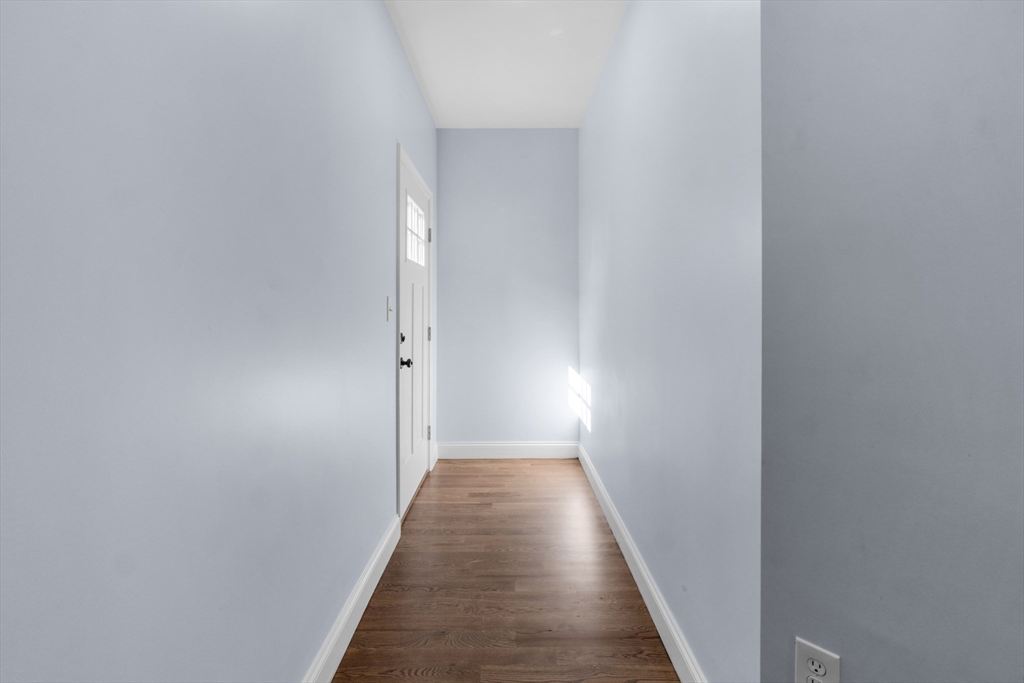 489 Spring Street Fall River, MA 02721 - Photo 14 of 42 a view of a hallway with wooden floor