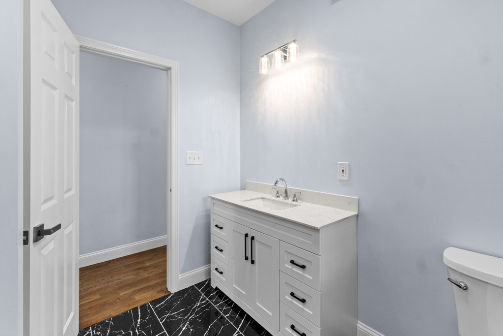 489 Spring Street Fall River, MA 02721 - Photo 18 of 42 a bathroom with a sink toilet and vanity