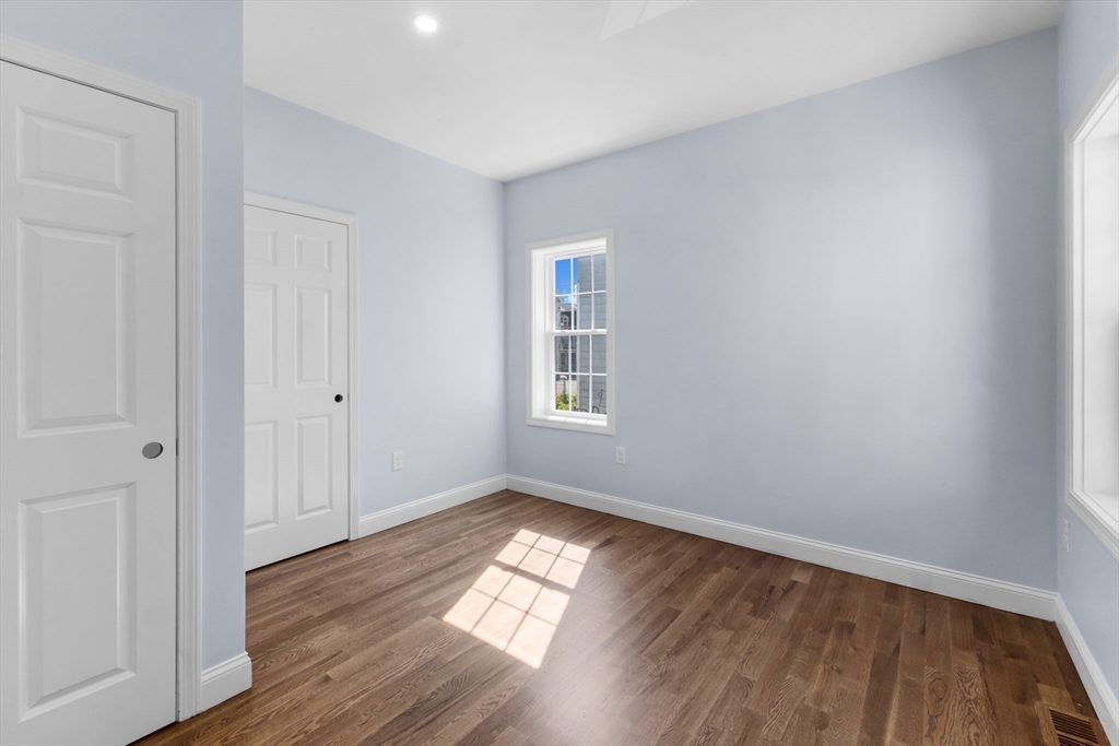 489 Spring Street Fall River, MA 02721 - Photo 19 of 42 a view of empty room with wooden floor and fan