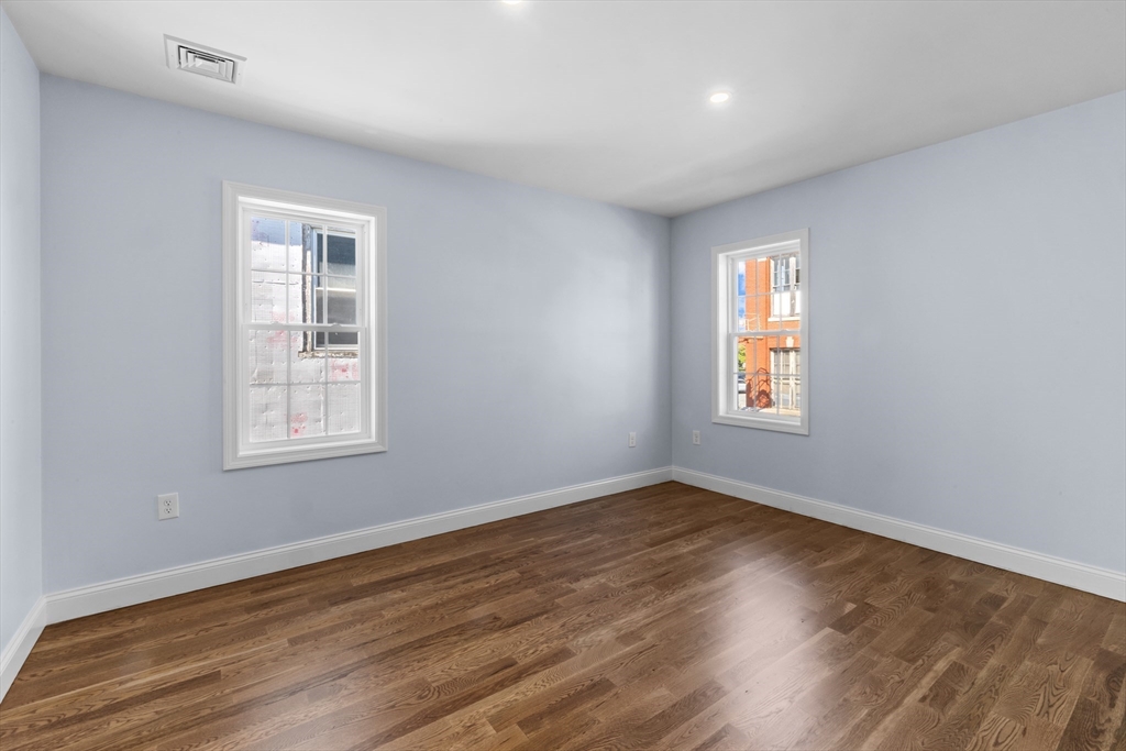 489 Spring Street Fall River, MA 02721 - Photo 20 of 42 a view of an empty room with wooden floor and a window