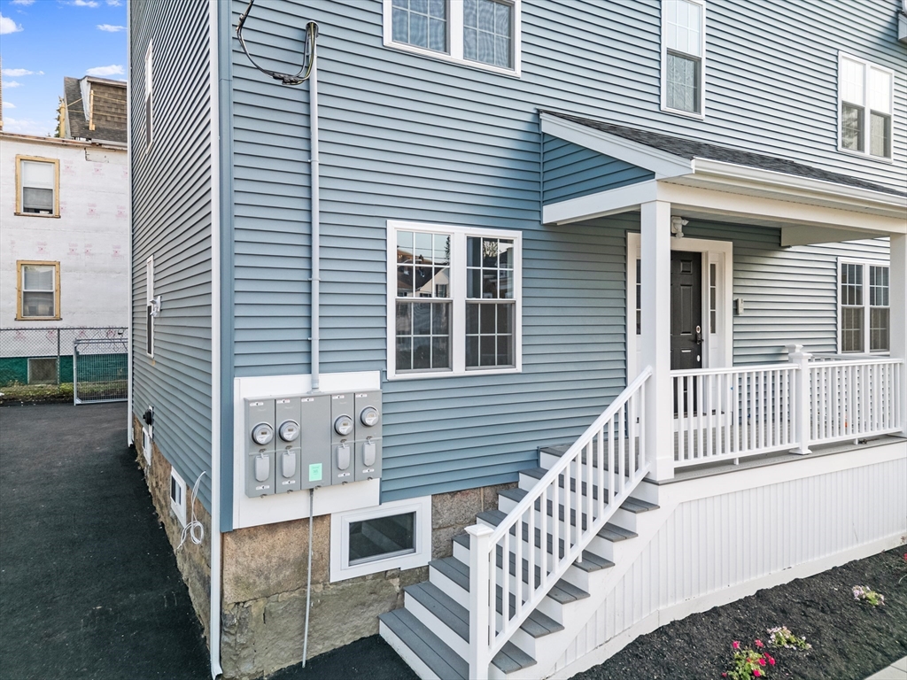 489 Spring Street Fall River, MA 02721 - Photo 2 of 42 a view of a house with a small deck