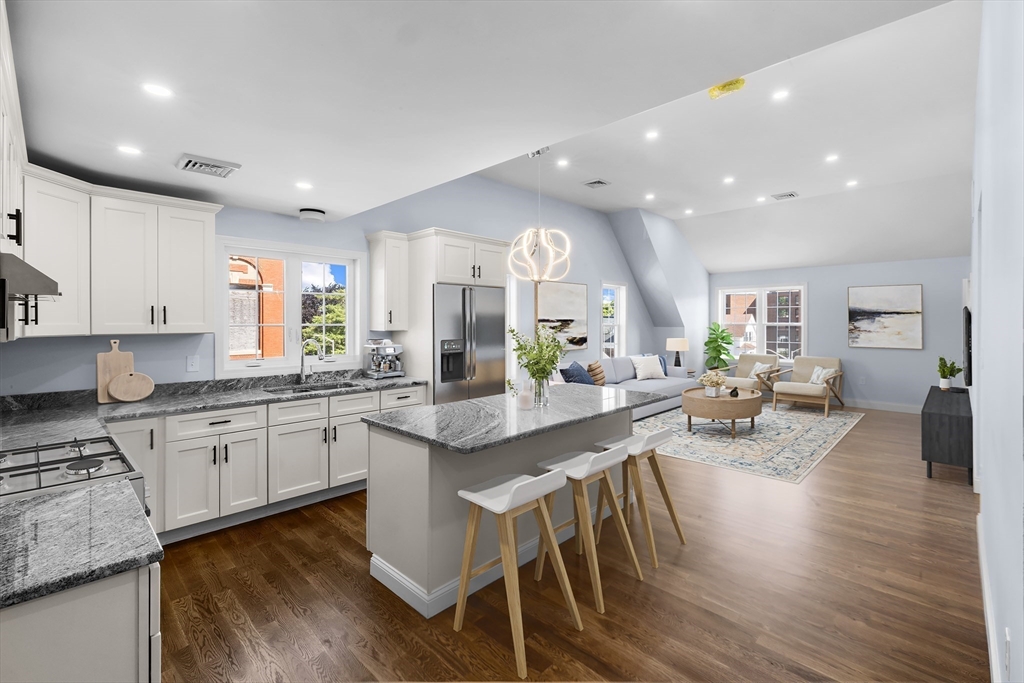 489 Spring Street Fall River, MA 02721 - Photo 24 of 42 a kitchen with sink stove and wooden floor