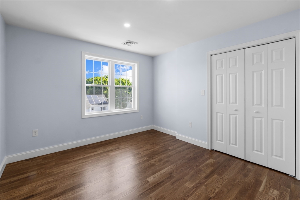489 Spring Street Fall River, MA 02721 - Photo 25 of 42 a view of an empty room with wooden floor and a window