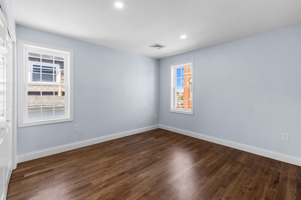 489 Spring Street Fall River, MA 02721 - Photo 30 of 42 a view of an empty room with wooden floor and a window