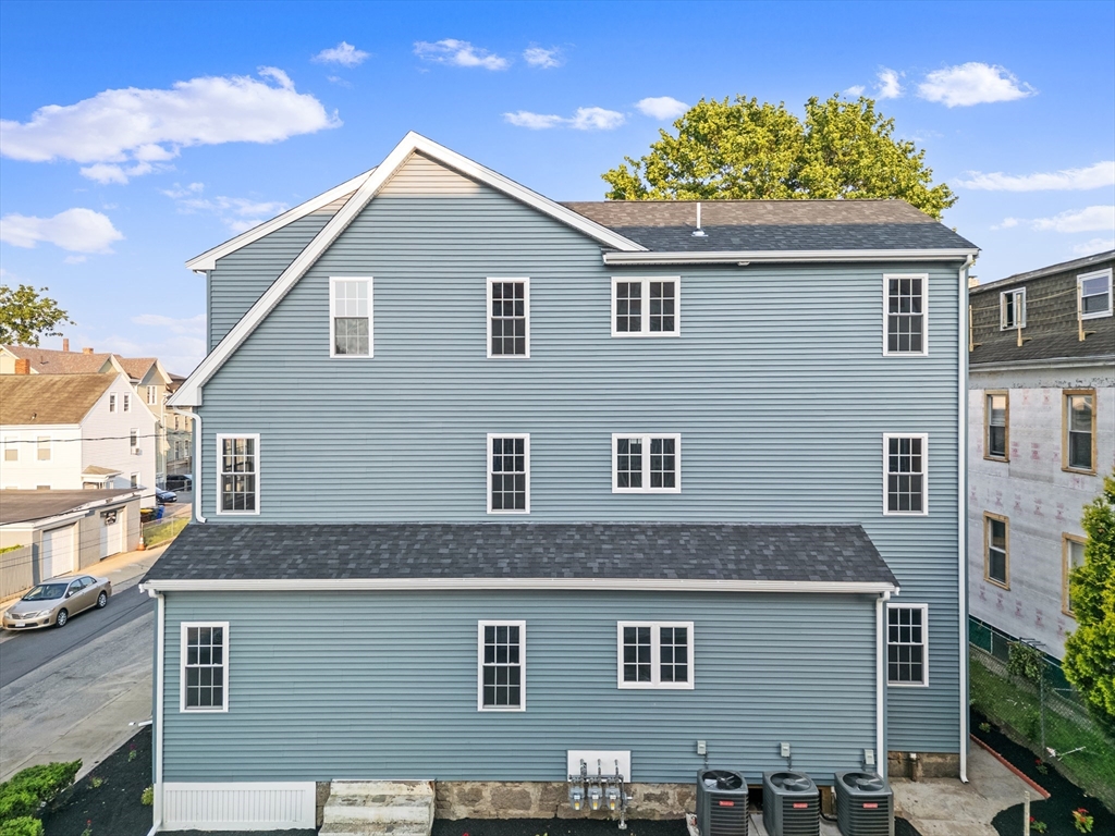 489 Spring Street Fall River, MA 02721 - Photo 3 of 42 a front view of a house with a yard