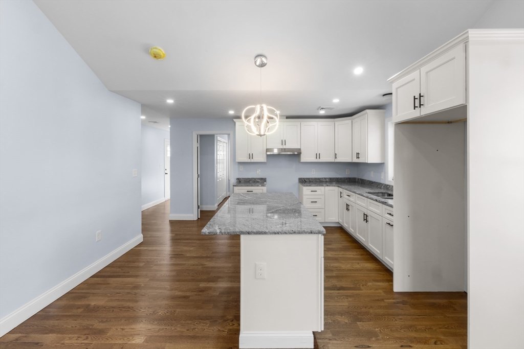 489 Spring Street Fall River, MA 02721 - Photo 31 of 42 a kitchen with kitchen island a sink stainless steel appliances and cabinets