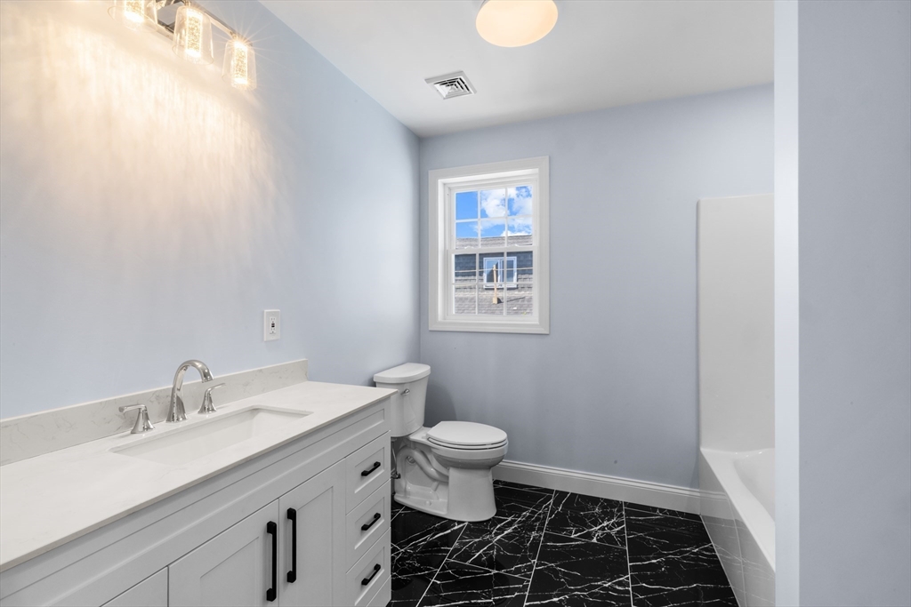 489 Spring Street Fall River, MA 02721 - Photo 32 of 42 a bathroom with a sink a toilet and a window