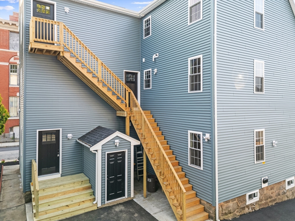489 Spring Street Fall River, MA 02721 - Photo 40 of 42 a front view of a house with wooden stairs