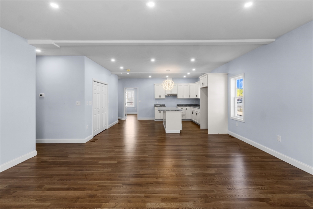 489 Spring Street Fall River, MA 02721 - Photo 6 of 42 a view of kitchen and hall with wooden floor