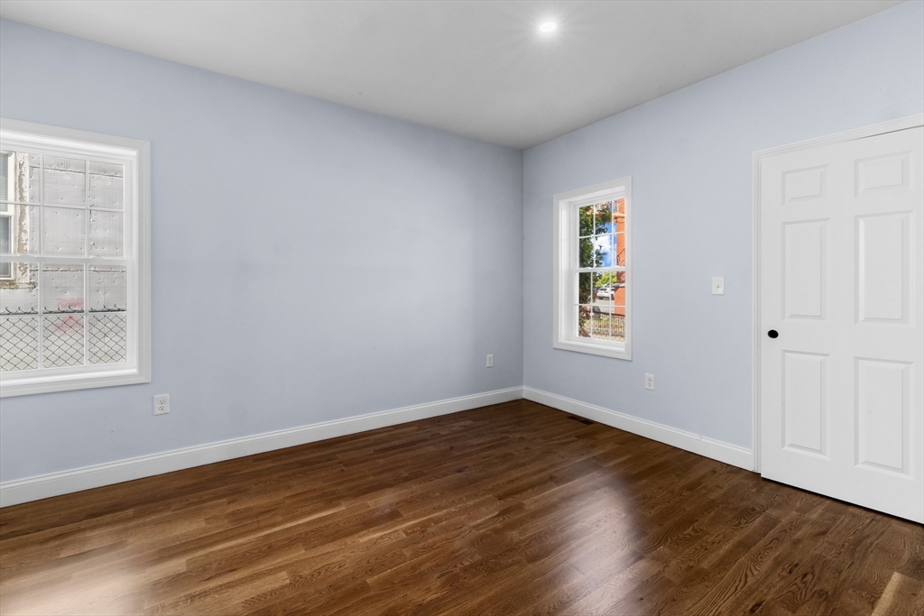 489 Spring Street Fall River, MA 02721 - Photo 8 of 42 a view of an empty room with wooden floor and a window