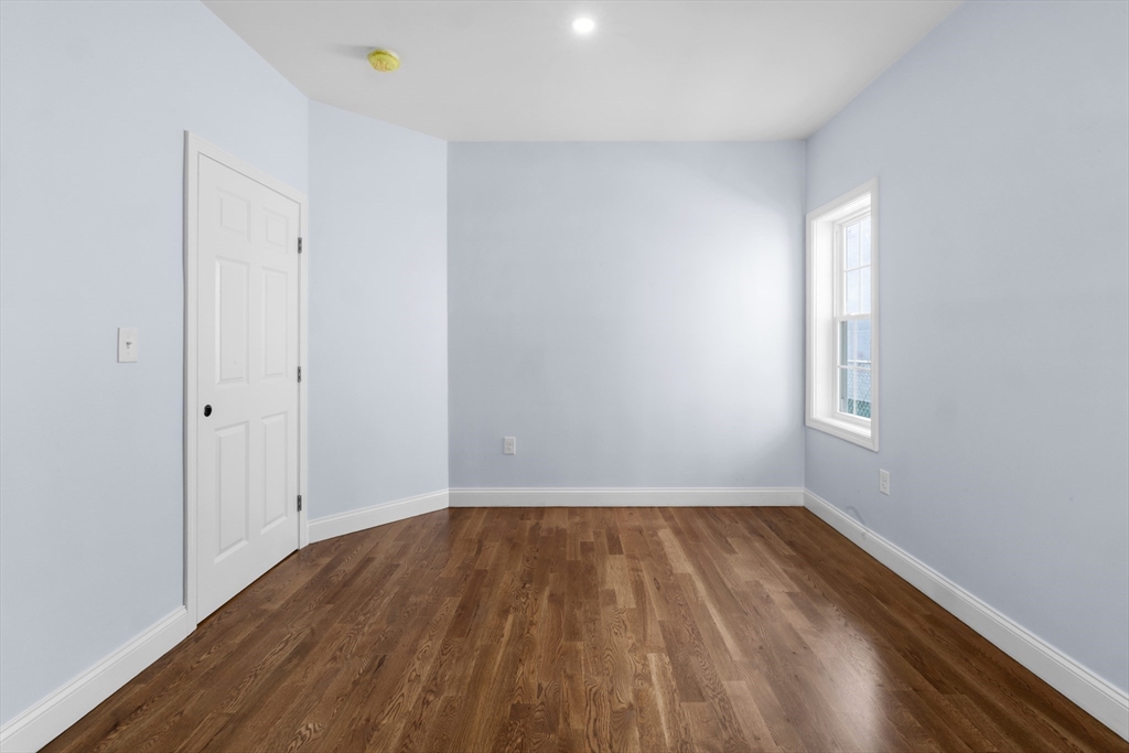 489 Spring Street Fall River, MA 02721 - Photo 9 of 42 a view of room with window and wooden floor