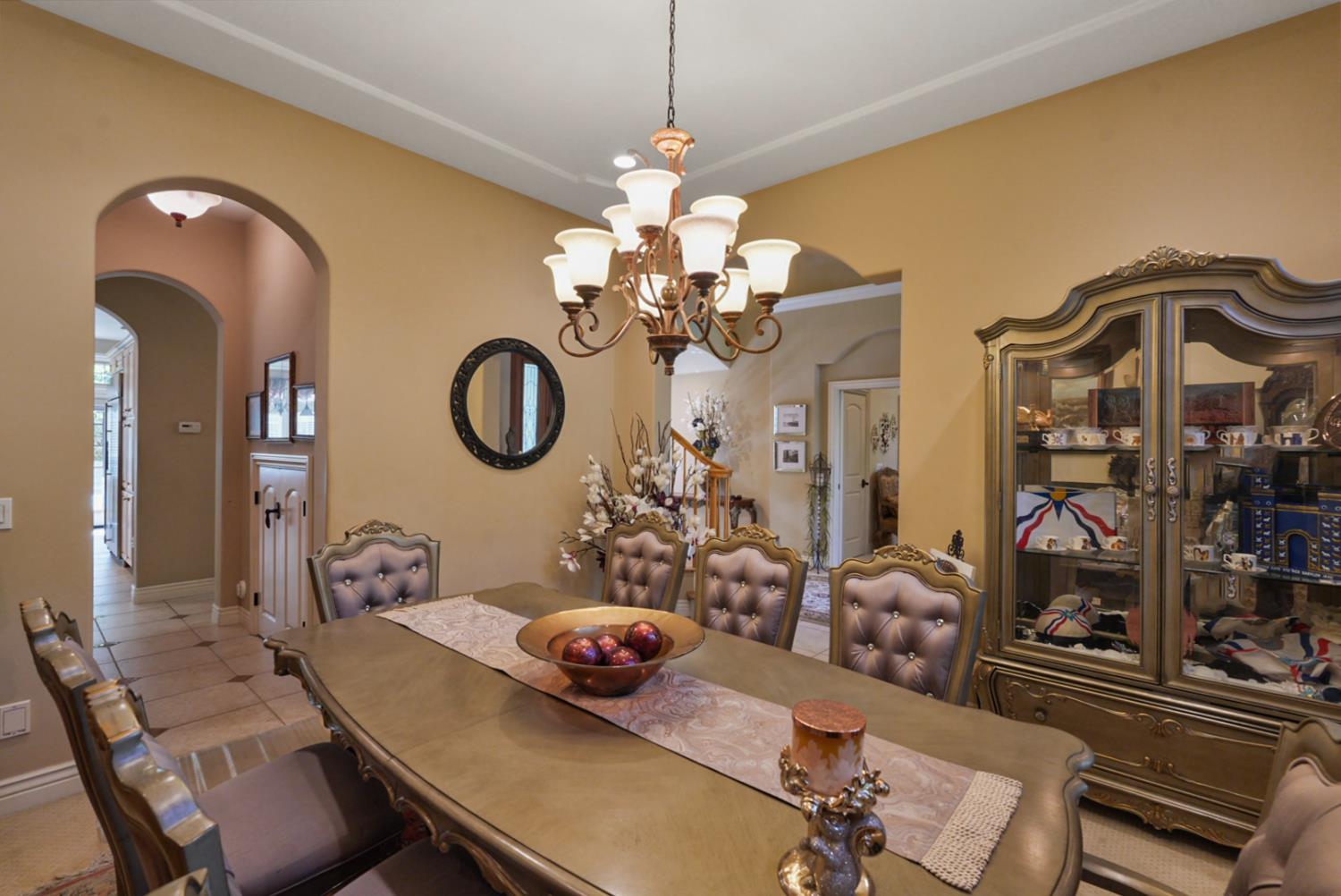 2575 Kensington Court Turlock, CA 95382 - Photo 12 of 62 a view of a dining room with furniture and chandelier