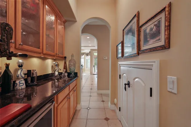 a large kitchen with stainless steel appliances granite countertop a stove a sink and a microwave