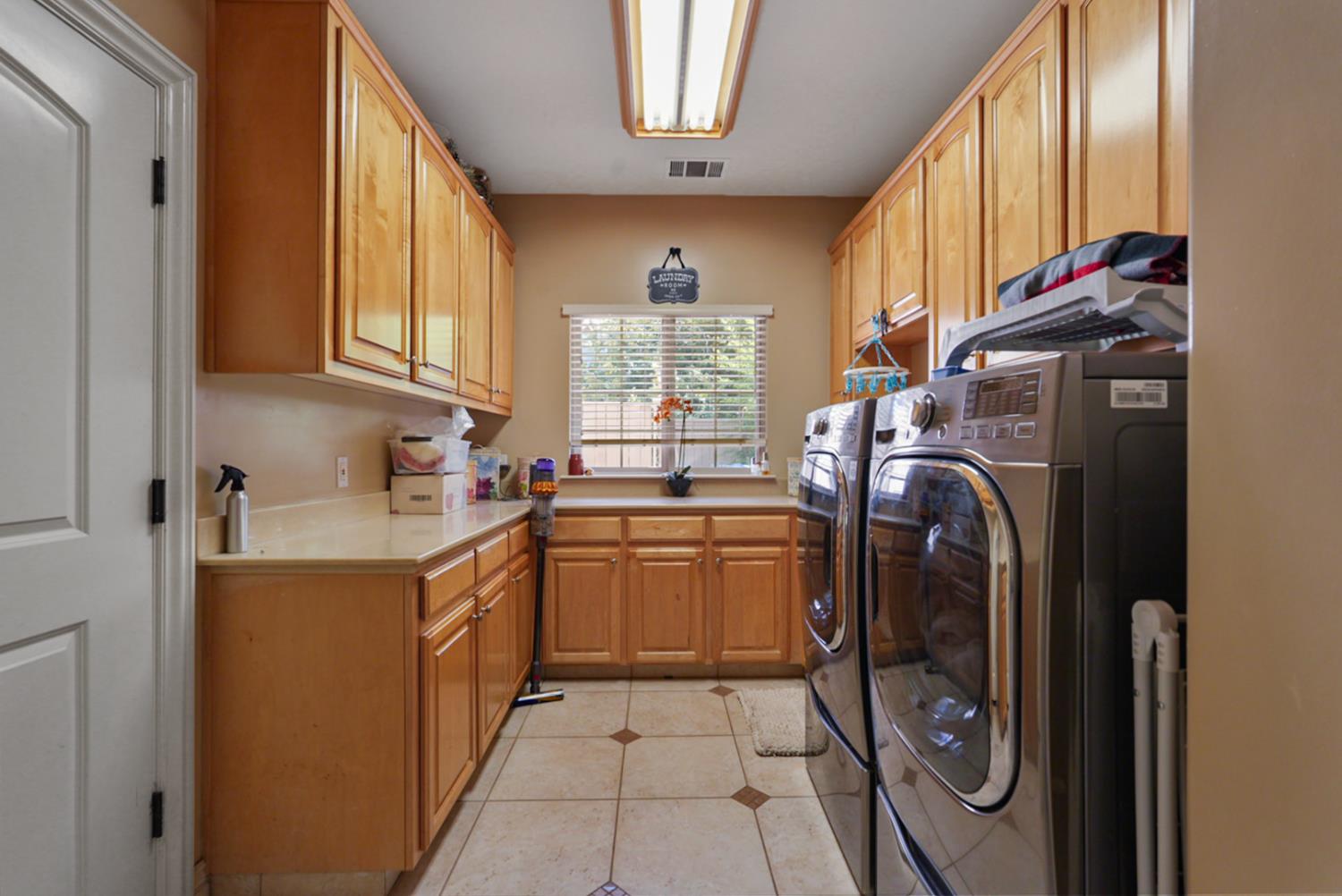 2575 Kensington Court Turlock, CA 95382 - Photo 14 of 62 a kitchen with refrigerator and washer