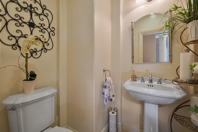 a en suite bathroom with a granite countertop sink and a mirror