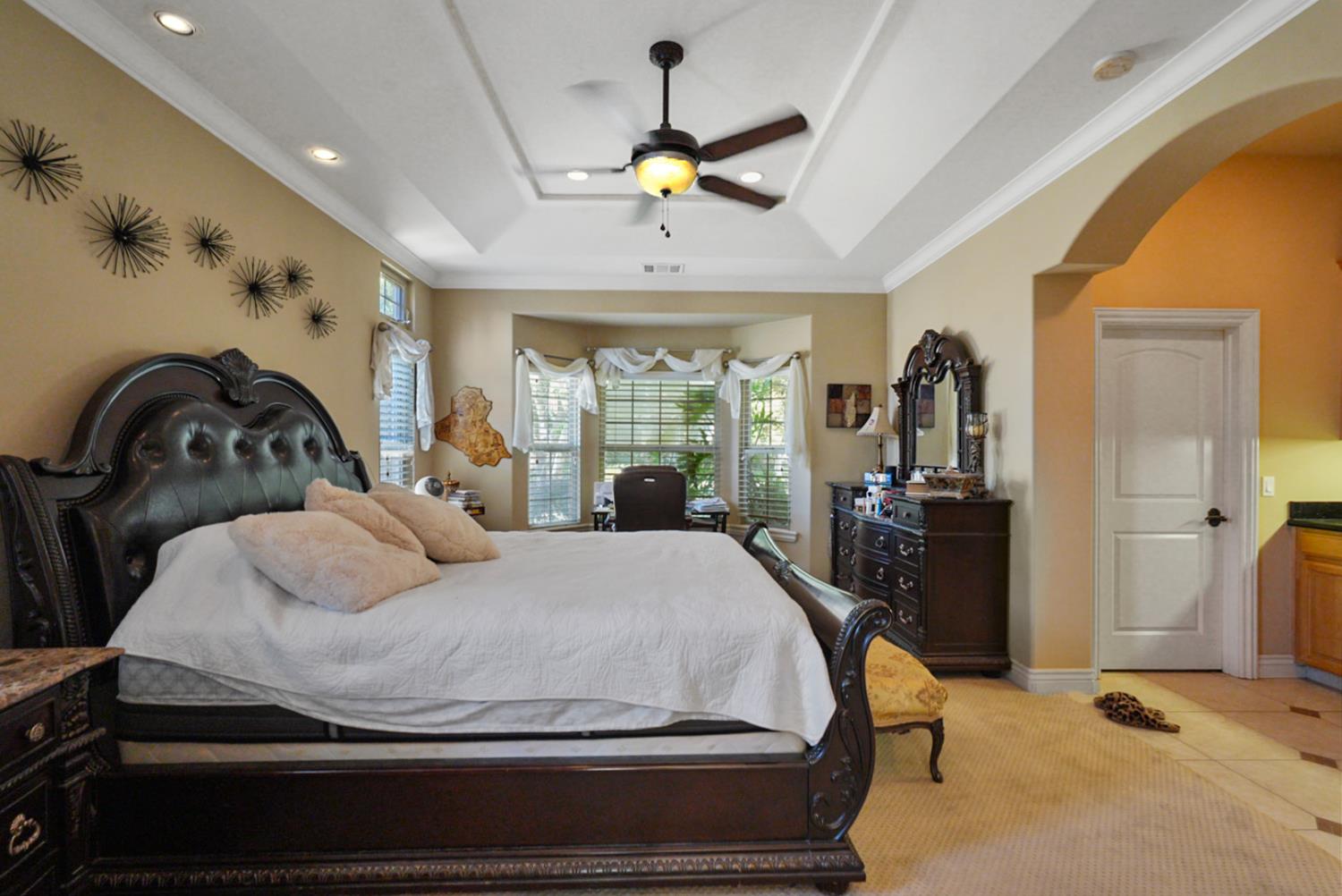 2575 Kensington Court Turlock, CA 95382 - Photo 24 of 62 a bedroom with a bed and a chandelier