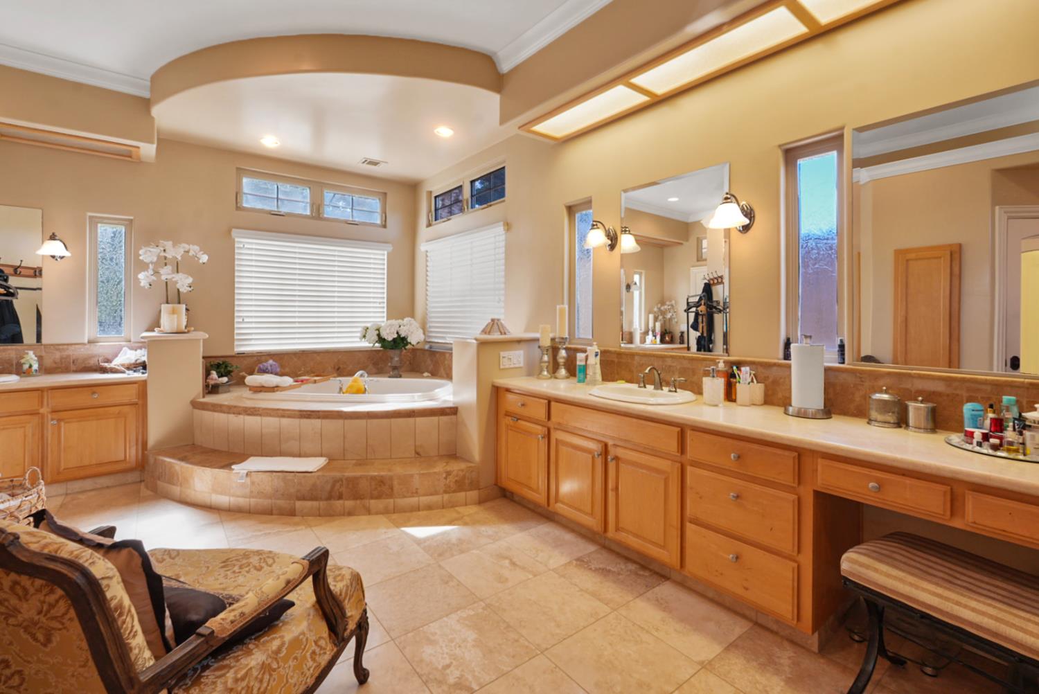 2575 Kensington Court Turlock, CA 95382 - Photo 26 of 62 a large bathroom with a double vanity sink a mirror and a bathtub