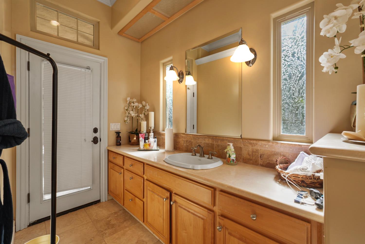 2575 Kensington Court Turlock, CA 95382 - Photo 27 of 62 a en suite bathroom with a granite countertop sink and a mirror