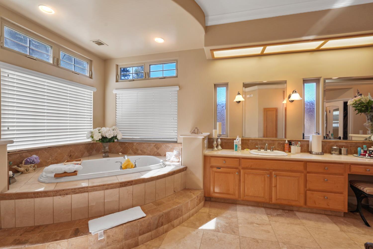 2575 Kensington Court Turlock, CA 95382 - Photo 28 of 62 a bathroom with a tub sink and mirror