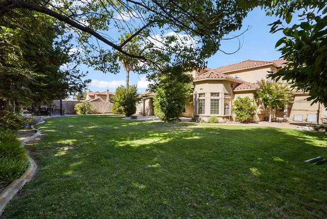 a kitchen with stainless steel appliances granite countertop a refrigerator and a stove