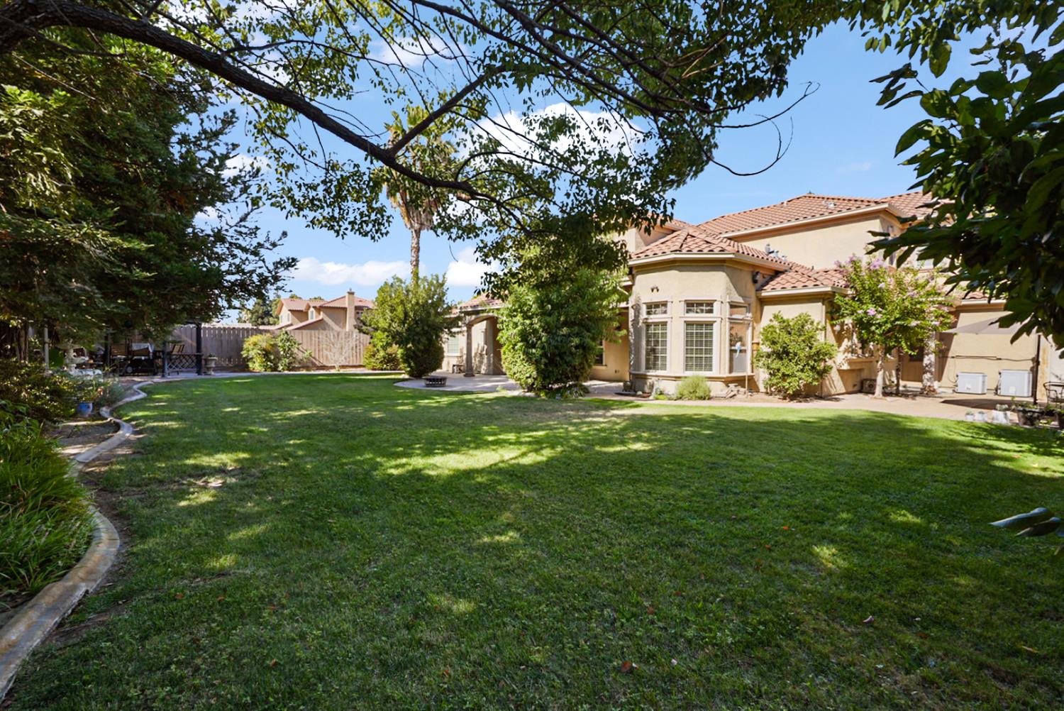 2575 Kensington Court Turlock, CA 95382 - Photo 32 of 62 a view of a house with a tree in a yard