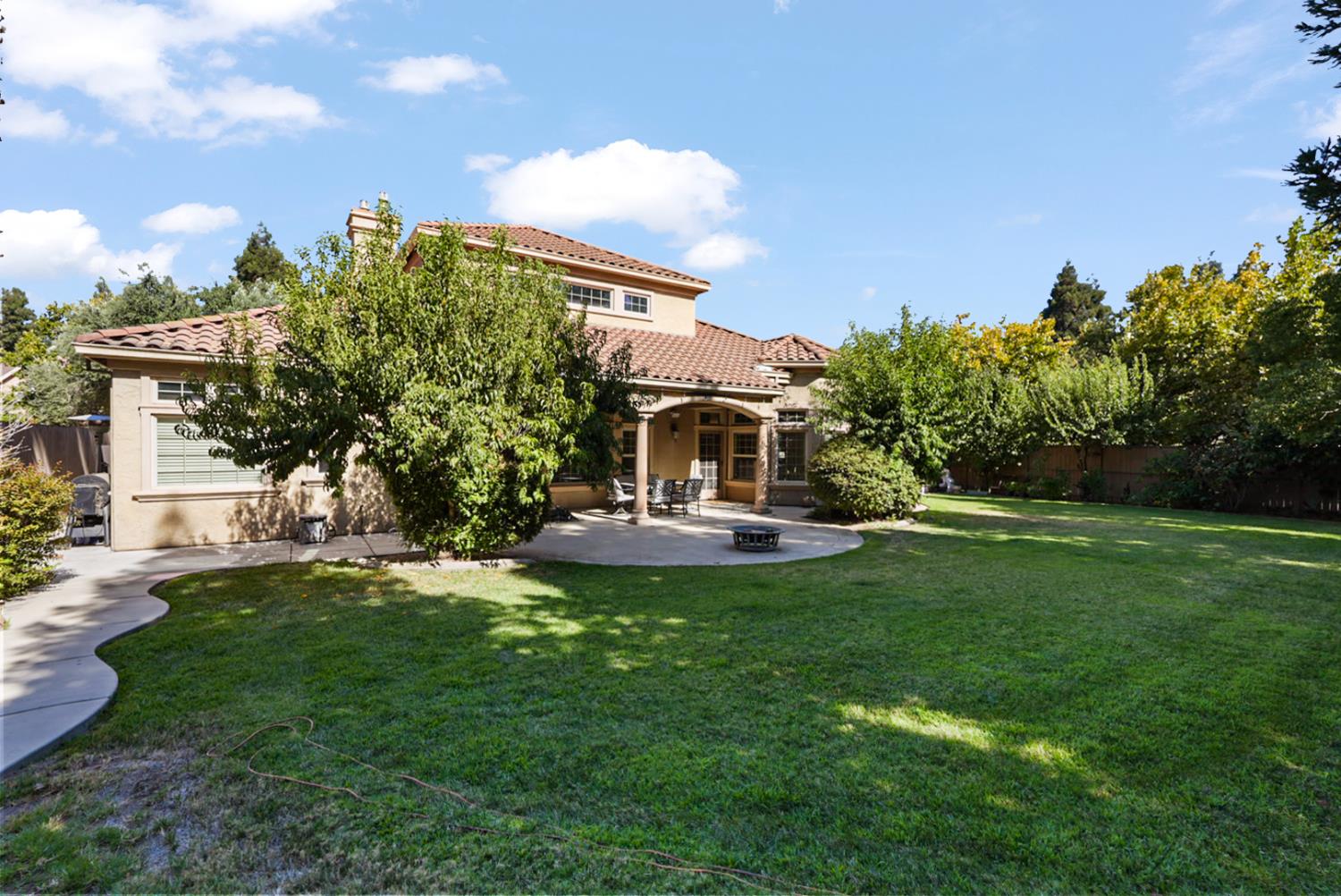 2575 Kensington Court Turlock, CA 95382 - Photo 34 of 62 a front view of a house with garden and trees