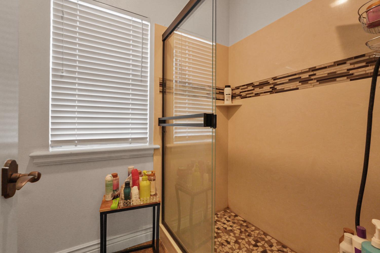 2575 Kensington Court Turlock, CA 95382 - Photo 46 of 62 a bathroom with a shower and a window