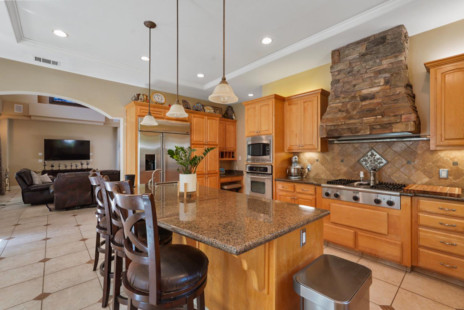 2575 Kensington Court Turlock, CA 95382 - Photo 7 of 62 a kitchen with stainless steel appliances granite countertop a stove a sink and a refrigerator