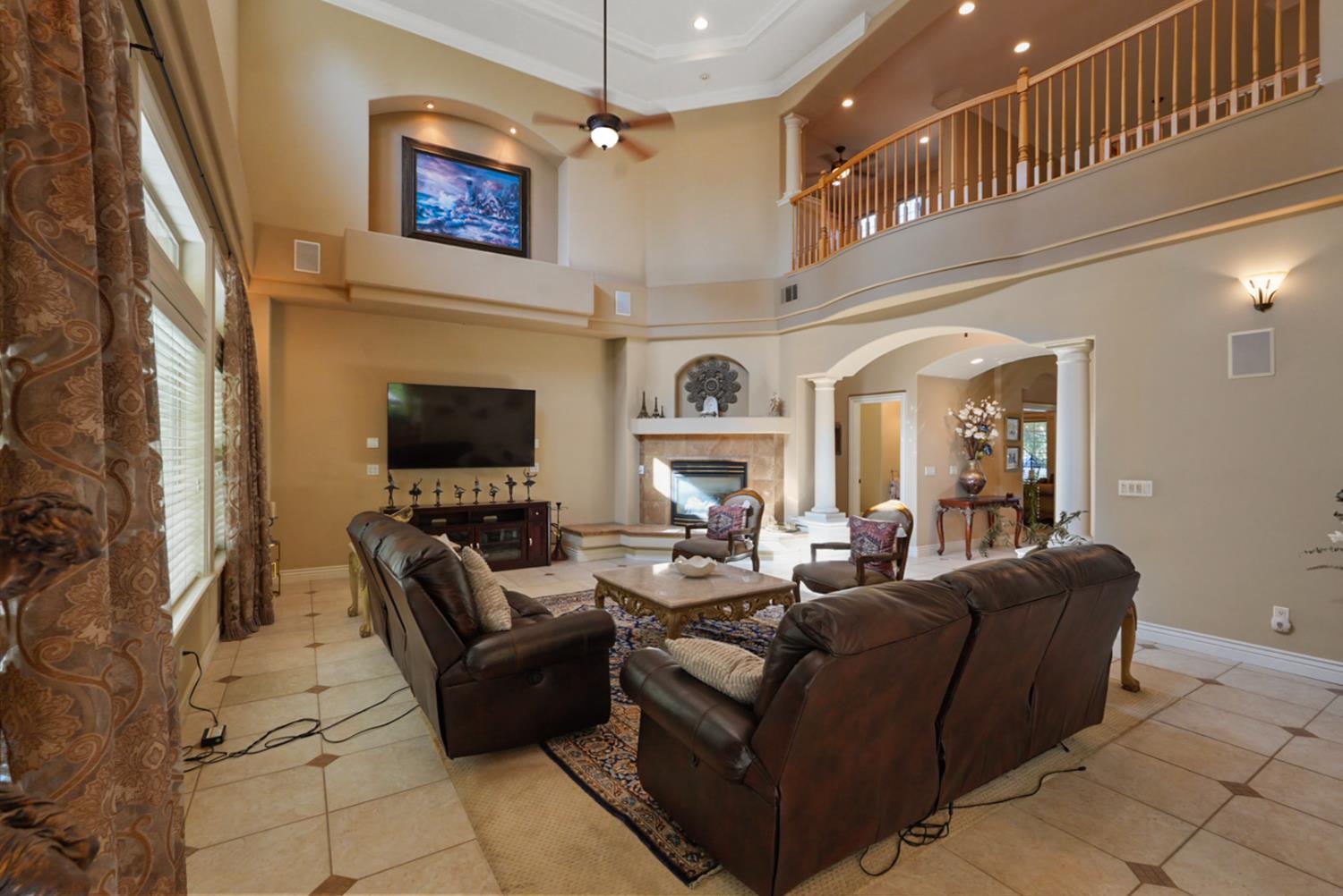 2575 Kensington Court Turlock, CA 95382 - Photo 8 of 62 a living room with fireplace furniture and a flat screen tv