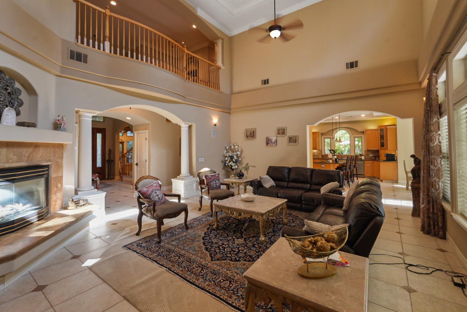 2575 Kensington Court Turlock, CA 95382 - Photo 9 of 62 a living room with furniture a fireplace and potted plants