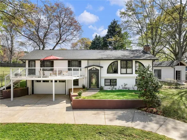 a front view of a house with a garden and patio
