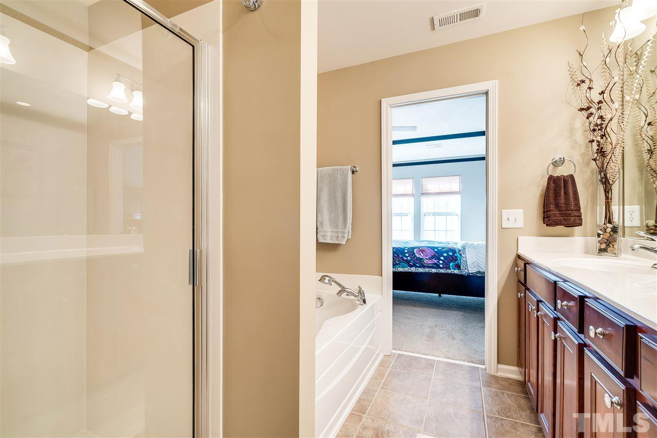 8317 Deckbar Place Raleigh, NC 27617 - Photo 17 of 25 include double vanity, tile floor, garden tub, separate shower, and walk-in closet.