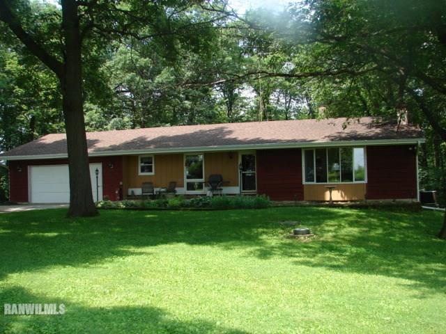 a front view of a house with a garden and porch