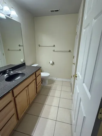 a bathroom with a sink a toilet and a mirror