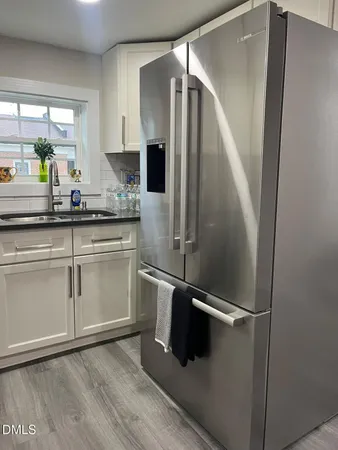 a kitchen with stainless steel appliances a refrigerator and a sink