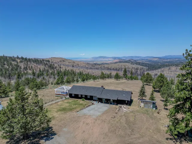 an aerial view of a house with a yard