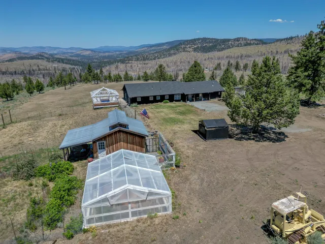 a view of a house with a yard and potted plants