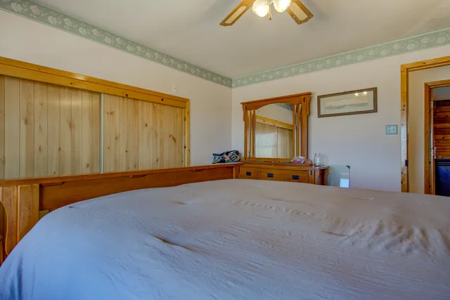 a bed room with a bed and a chandelier