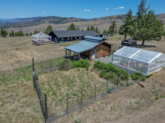 an aerial view of a house with a yard and lake view