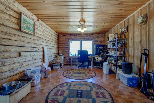 a living room with furniture and a book shelf