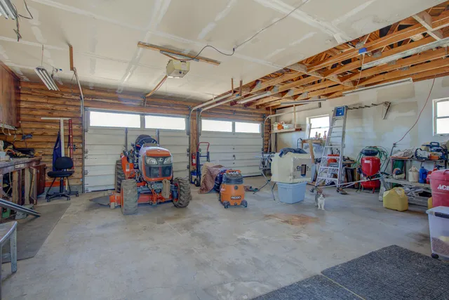 a view of a garage with a bike and white car