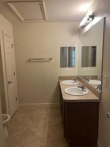 a kitchen with a refrigerator and a sink