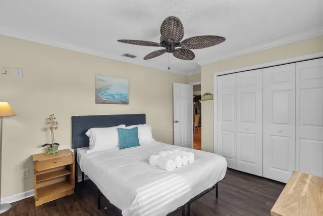 a bedroom with a bed and a chandelier