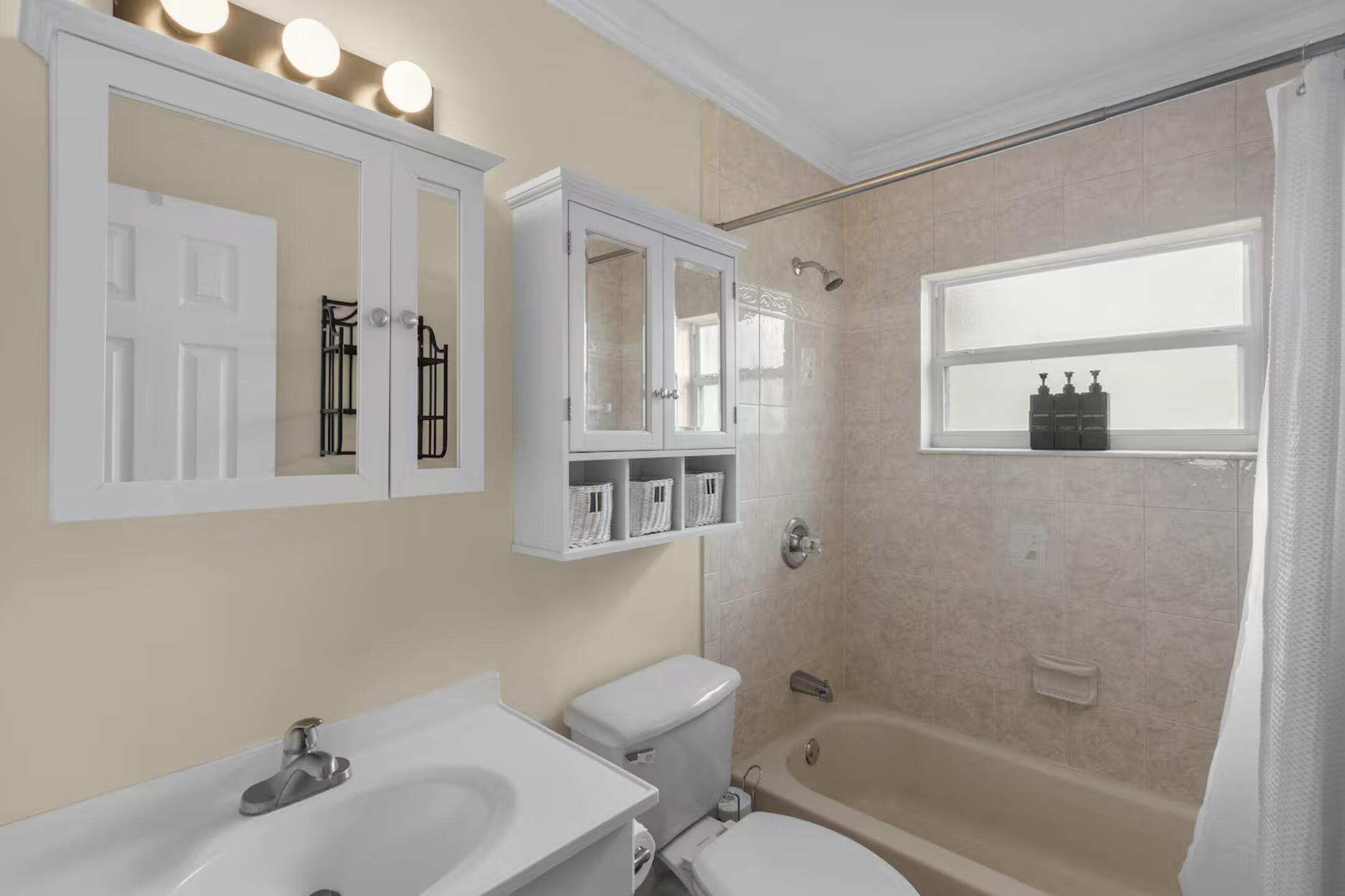 991 Southeast Walters Terrace Port St. Lucie, FL 34983 - Photo 16 of 19 a bathroom with a bathtub shower sink and mirror