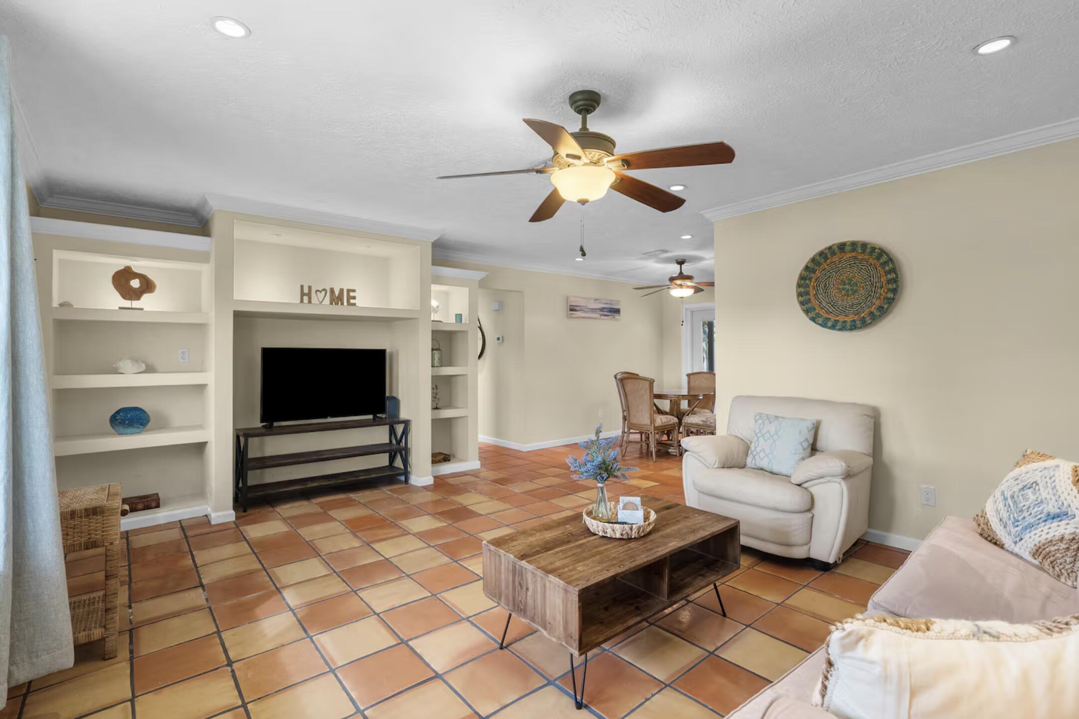 991 Southeast Walters Terrace Port St. Lucie, FL 34983 - Photo 4 of 19 a living room with furniture a flat screen tv and a window