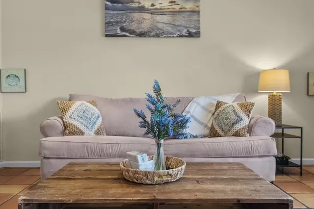 a living room with furniture and a lamp