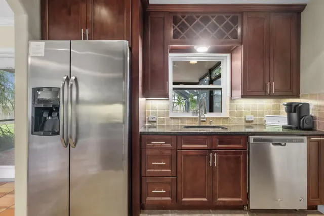 a kitchen with a refrigerator and cabinets