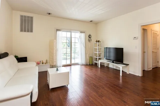 a living room with furniture wooden floor and a flat screen tv