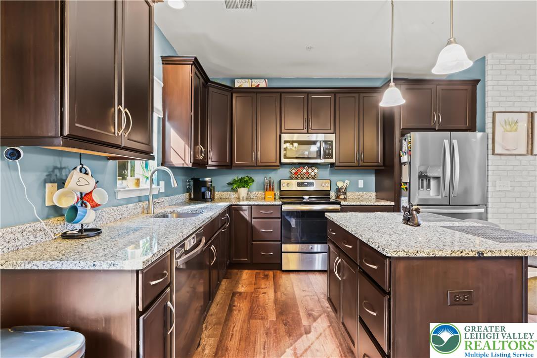 2260 Rising Hill Road Whitehall, PA 18052 - Photo 11 of 30 a kitchen with stainless steel appliances granite countertop a sink stove and refrigerator