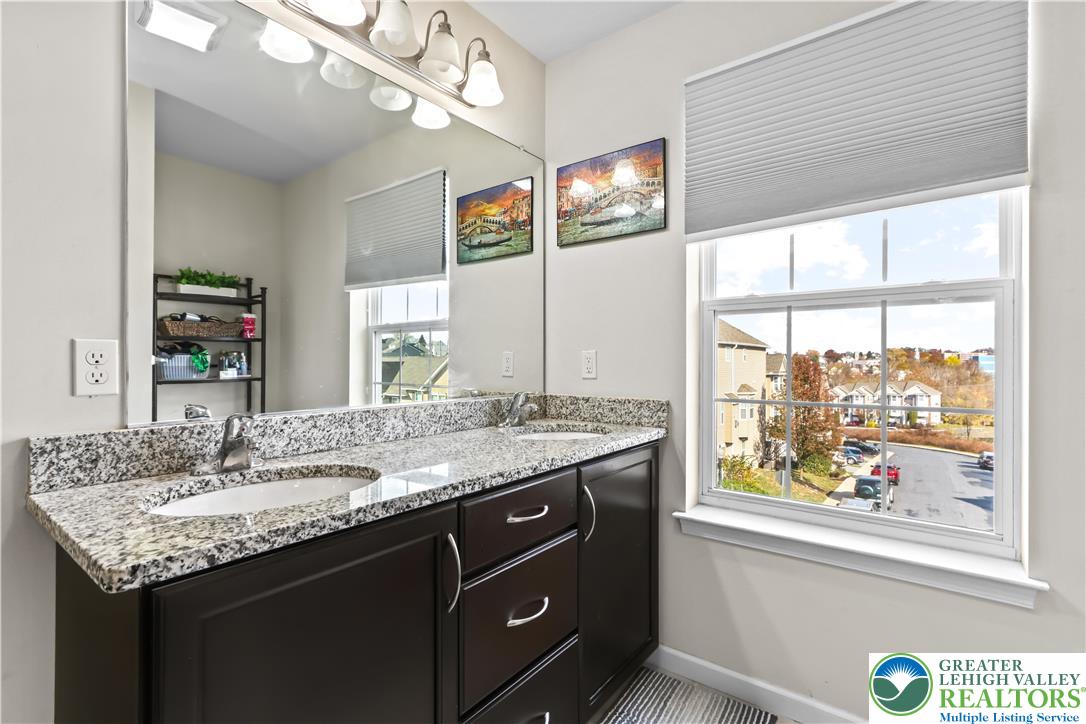 2260 Rising Hill Road Whitehall, PA 18052 - Photo 23 of 30 a bathroom with a granite countertop sink and a large mirror